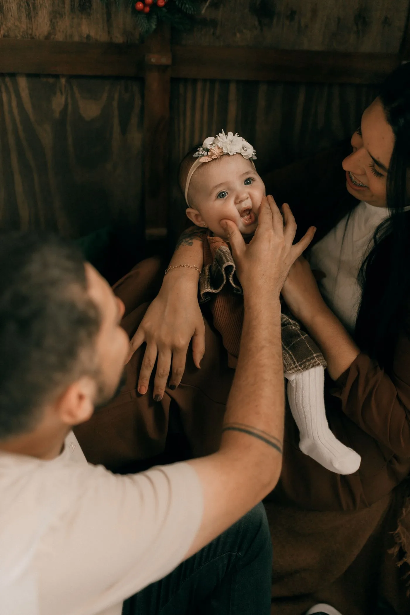 Zwei Erwachsene mit einem lächelnden Baby